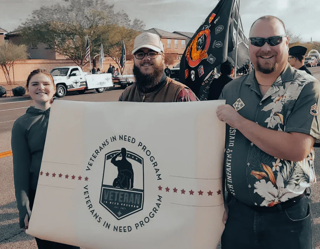 VINP board members at a community parade carrying the project's banner